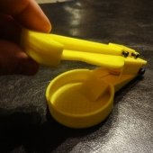 yellow plastic device with pill in its center