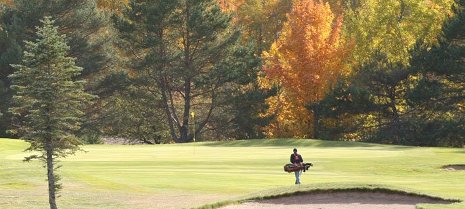 The last round: a lone golfer gets in his last round at Portage Lake Golf Course.