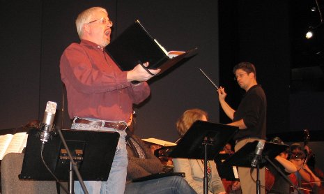 Tenor Charles White rehearses the Messiah with orchestra director Joel Neves looking on.