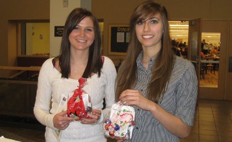Heather Marker (left) and Alex Mallos (Right) are thrilled with their holiday gift bags from the University Women's Connection.