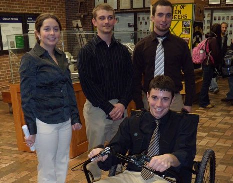 The Human Powered Off-Road Wheelchair team, left to right: Heather Robertson, Brad Szkrybalo, Josh Door, and  Michael Lecureux (seated). Missing is team member Karen Jarvey.