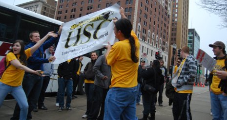 Michigan Tech students unfurl Undergraduate Student Government rally banner in Lansing.
