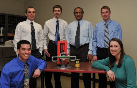 Mechanical engineering seniors William Donovan, Tyler LeRoy, Jonathan Hoyer, Adrian Simula and Lisa Staehlin, with advisor Rao Komaravolu (center right), and the OpensAll can and jar opener they developed.