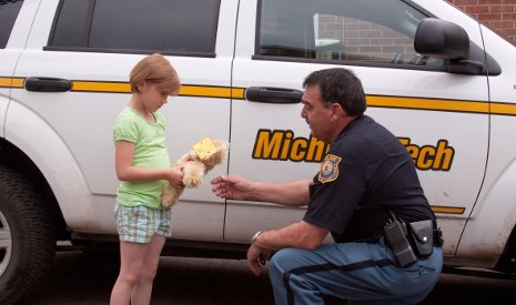 Paige Sleeman, daughter of Housing & Residential Life staff assistant Ginger Sleeman, checks out a DPSPS teddy bear.