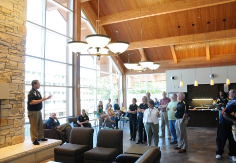Travis Pierce, director of housing, greets alumni and members of the campus community at the open house for Michigan Tech's new Residential Apartment Building