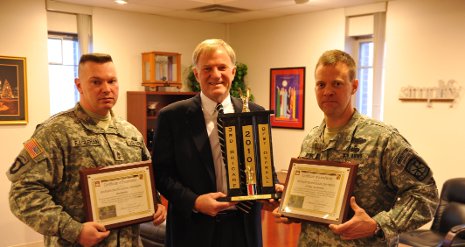 President Glenn Mroz (center) accepts awards for the ROTC Program from Master Sgt. James Eagleman (left) and Lt. Col. James Spence.