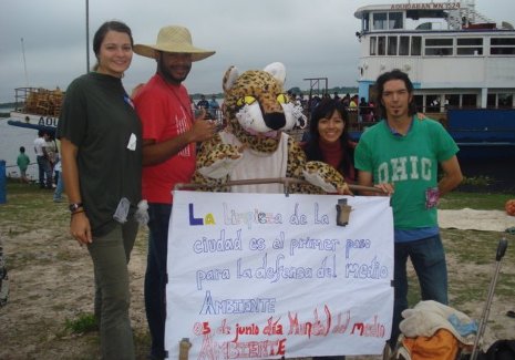 Peace Corps volunteer Michelle Cisz in Paraguay with local volunteers and their mascot, a jaguar used by the volunteers to get people interested in their community projects, like this street clean-up campaign. 