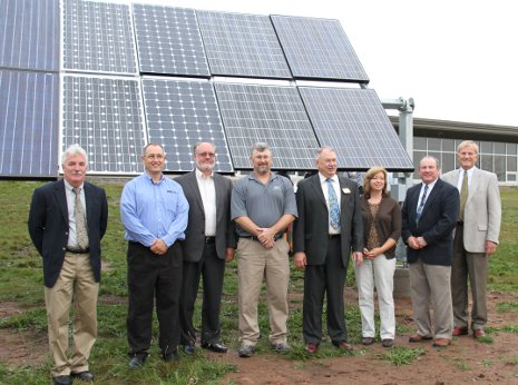 University and corporate officials stand by the Michigan Tech Solar Photovoltaic Research Facility during dedication ceremonies. 