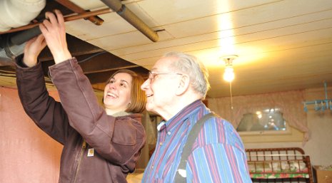 Enterprise student Chelsea Smith helped insulate the home of Loren Kommes of South Range. 