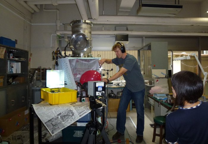 John Lyons running a acoustic tremor experiment in the laboratory of Mie Ichihara (also shown) at the Earthquake Research Institute, University of Tokyo, Japan. Cara Shonsey photo