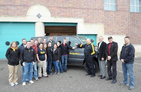 George Butvilas, facilities director, hands the keys for a van to student Erik Wachlin. Pictured, right to left, are Nicholas Hendrickson, School of Technology; Institute for Leadership and Innovation director Robert Warrington; and President Glenn Mroz.