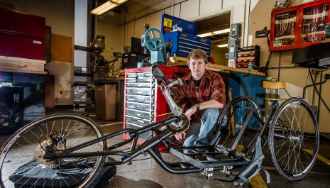 James Cook, a senior in mechanical engineering, works on The Tomahawk, one of two hand-cranked cycles that Senior Capstone Design teams built for wounded veterans who ride with the Achilles Freedom Team. 