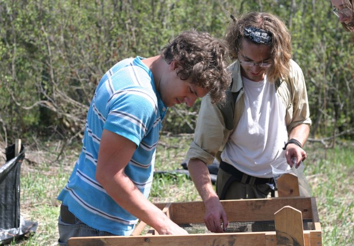 Jordan Berg and Connor Will screen soil to remove artifacts during the 2013 Cliff Mine Archaeology Project/Industrial Archaeology Field School.  Photo by Timothy Scarlett.