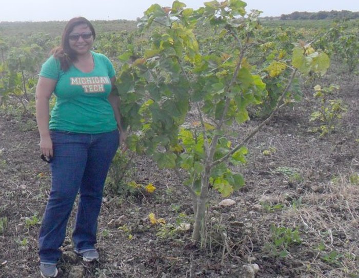 Mayra Sanchez Gonzalez is shown with a Jatropha plant, which is used for biofuel in her native Yucatan, Mexico.