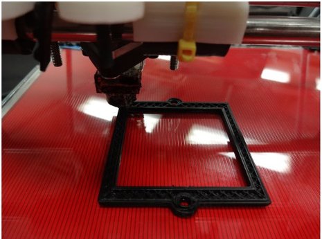 An open-source 3D printer printing an optical component, specifically, a filter bracket.