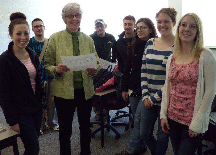 Beth Flynn and her last class gather, with Calvin and Hobbes.