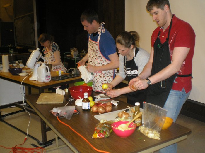 Students preparing dishes in the Cooking with a Physicist class: (l-r) Renee Batzloff, Colin Gurganus, Kathryn Cox, Jonathan Curtis