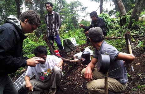 Jay Wellik, left, installs a new seismometer near Raung volcano.