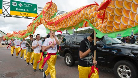 Chinese students weave their traditional dragon through the crowd at the Parade of Nations.