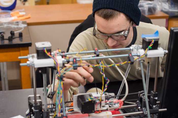 John Laureto printing a gear on a Rep Rap 3D printer in Joshua Pearce's lab at Michigan Tech. Laureto recently completed a BS in Materials Science and Engineering. Sarah Bird photo