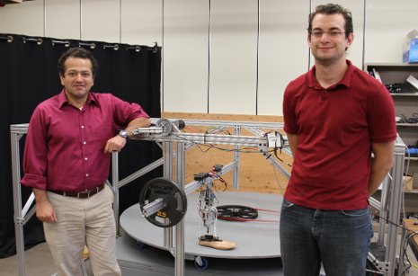 Assistant Professor Mo Rastgaar and PhD student Evandro Ficanha with their new computer-driven foot. The ankle can mimic a natural walk, allowing the foot to walk in circles on the circular treadmill, shown. Emil Groth photo