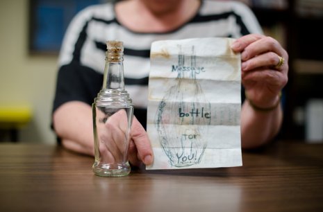 Nancy Auer with the bottle set loose by a Minnesota family near Thunder Bay. It found its way to her home near Eagle River.