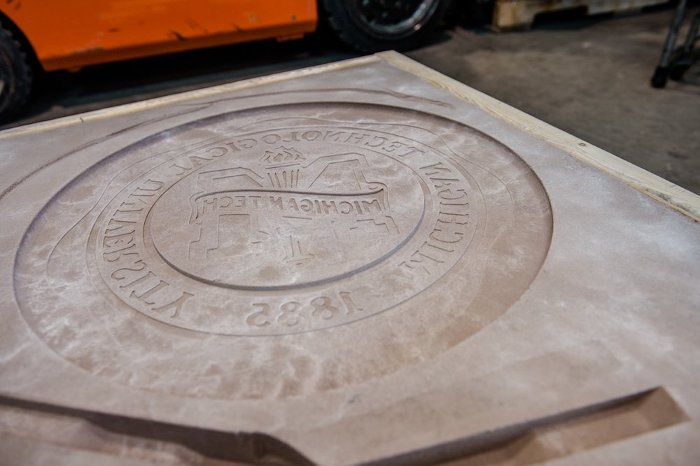 The sand mold for Michigan Tech's University seal, made by student Matt Dazell using an aluminum pattern developed by Nick Hendrickson of the School of Technology.