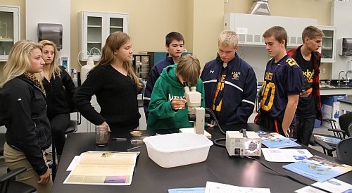 High school students analyze water samples they collected while out on the Agassiz, Michigan Tech's research vessel.