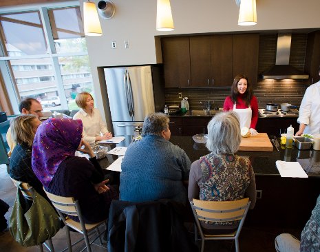 A Community ESL student presents recipes from her home nation to Tech staff and faculty at a healthy cooking lesson. Her presentation was part of the final project for the class.