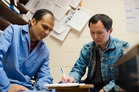 PhD candidate Durga Pokharel, left, and his advisor, chemist Shiyue Fang, working out solutions to challenges in their research on purifying DNA and peptide molecules. Sarah Bird photo