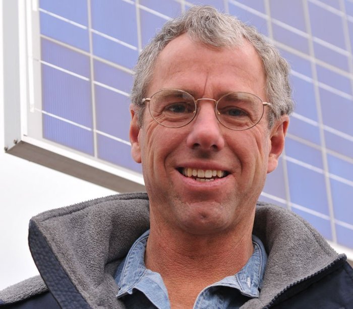 Mark Roberts In front his solar panels at his house.