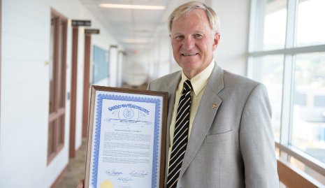 Glenn Mroz accepted a plaque from the State of Michigan, honoring Michigan Tech.