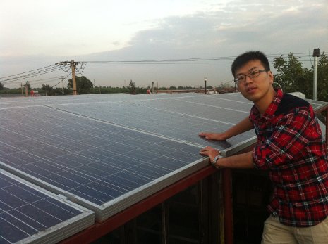 Yawei Wei inspects the solar panels he and his family installed on his cousin's roof in the rural Chinese community of Zao Yuan.