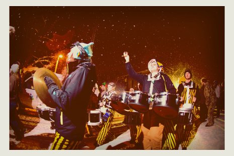 Pep Band marching walking through campus in the snow.