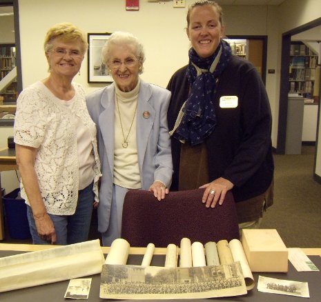 Ellen Raymond, center, donated her father-in-law's memorabilia from nearly a century ago to the Michigan Tech Archives at the suggestion of her friend, Sharon Eklund, left. Archivist Beth Russell called the gifts "a wonderful collection."