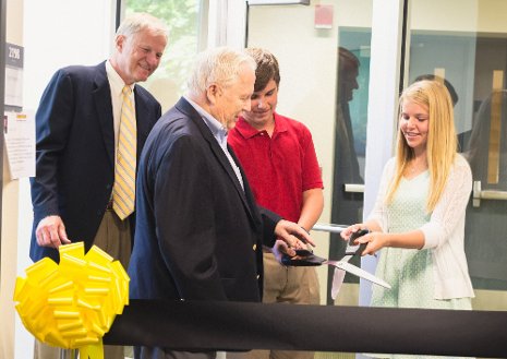 William Jackson '58 and his grandchildren, Cole and Robin, cut the ceremonial ribbon dedicating the William G. Jackson Center for Teaching and Learning, while Michigan Tech President Glenn Mroz looks on. Photo: Bryana Riutta, brockit inc.