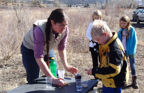 Rhianna Williams, a Michigan Tech master's degree student and OSM/VISTA volunteer, teaches children to test water quality in a Riverwatch program in Colorado.