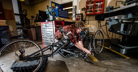 Michigan Tech Senior Design student works on one of the team's handcycle prototypes.
