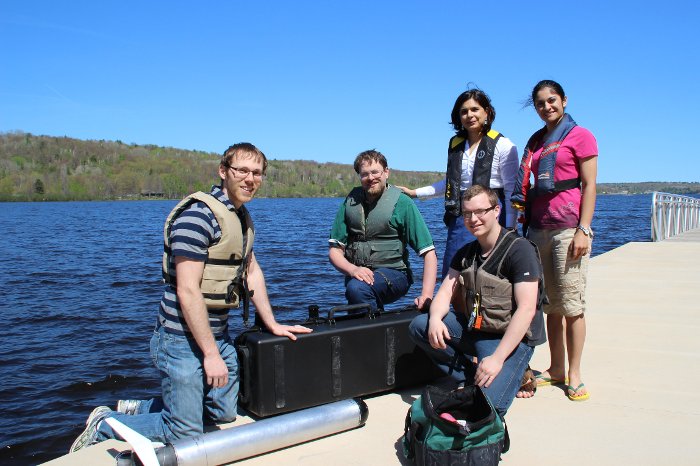 A test run for ROUGHIE Nina Mahmoudian, second from right, and her team of student researchers on the Michigan Tech waterfront, prepare to launch their underwater drone, ROUGHIE, in Portage Lake.