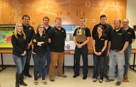 AFRL Senior Design Winning Senior Design team, from the left: Jessica Buck, Sean Mackey, Sophia Rizzo, Nicholas Sill (in the back), John Schuman, Joshua Kizer (wearing the suit), Jaclyn Johnson, Mikhail Alexander, Kevin Johnson, Bill Endres.
