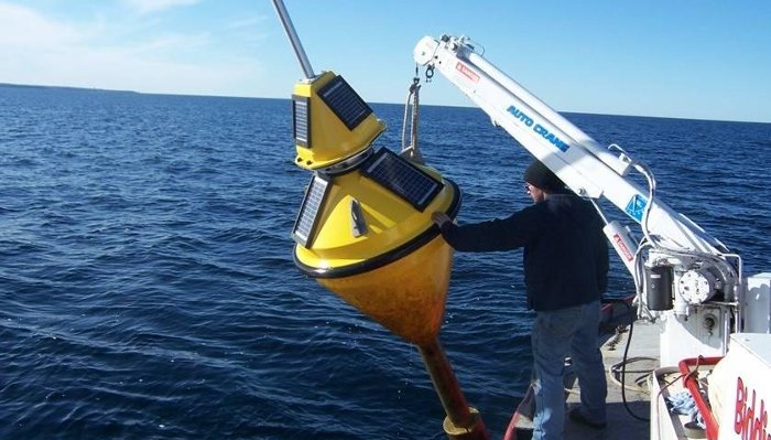 Deploying the Buoy Deploying the buoy to monitor water conditions in the Straits of Mackinac.
