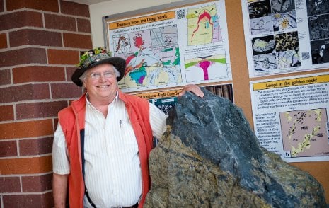 Professor Emeritus Bill Rose with the 3.5 ton nickel-copper sulfide boulder from the Eagle Mine.