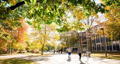 Students walking on campus near Fisher Hall.