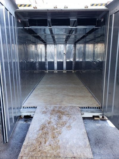 inside of a shipping container lined with reflective panels