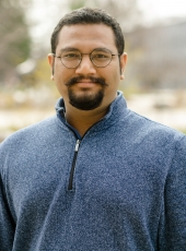 Man with glasses smiling