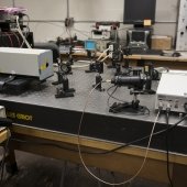 Lab table with laser and lenses set up.