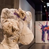 Female human abstract shape of bust made of fabric material standing in a gallery.