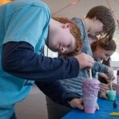 Students poking colored foam cups during an experiment with Mind Trekkers.