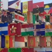 International flags hanging from a ceiling.