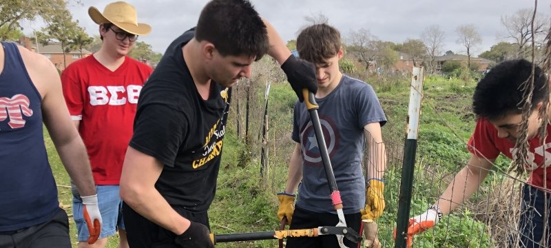 Students fixing a fence.